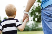 after establishing paternity, the father walks hand in hand with his child